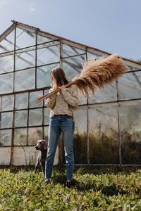 Woman standing by plants against sky