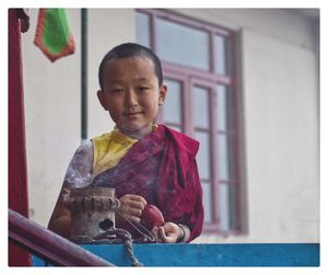 Portrait of smiling boy standing outdoors