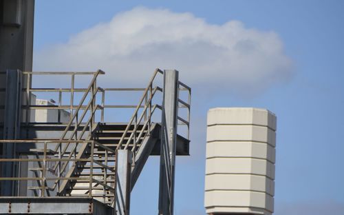 Low angle view of factory against sky