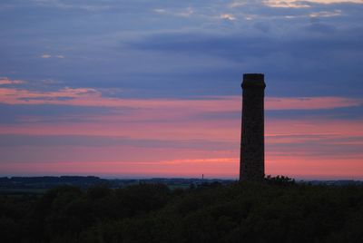 Silhouette tower against sky at sunset