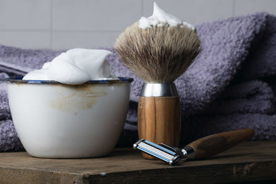 Close-up of shaving equipment on table