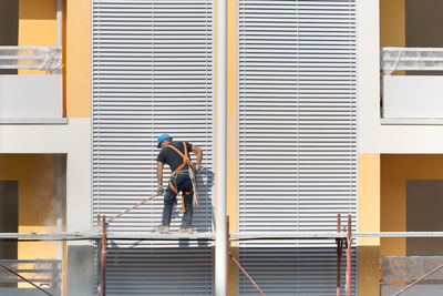 Man working at construction site against building