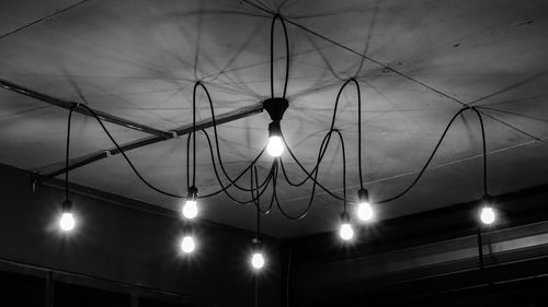 Low angle view of illuminated lamp against sky at night