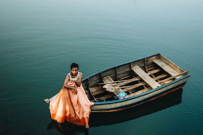 High angle view of man standing on boat in sea