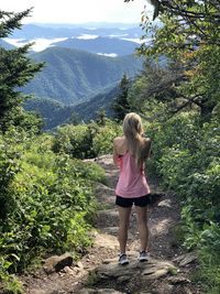 Rear view of woman standing on mountain