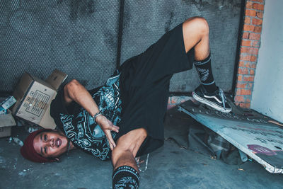 Low section of man sitting on floor