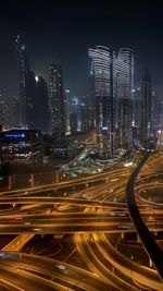 High angle view of illuminated dubai city at night with lights 