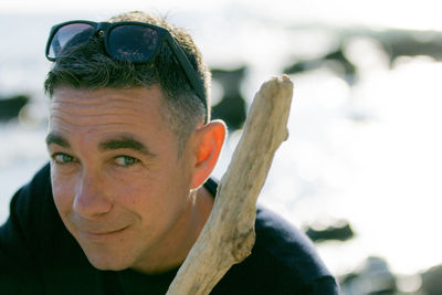 Close-up portrait of mid adult man against sky