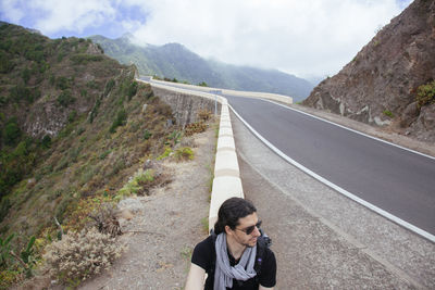 Portrait of man on road against mountains