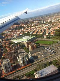 Cropped image of airplane flying over cityscape