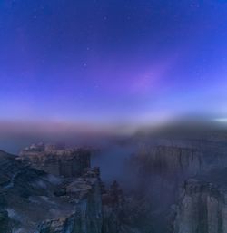 Scenic view of mountains against sky at night