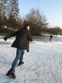 Full length of man skating on ice rink