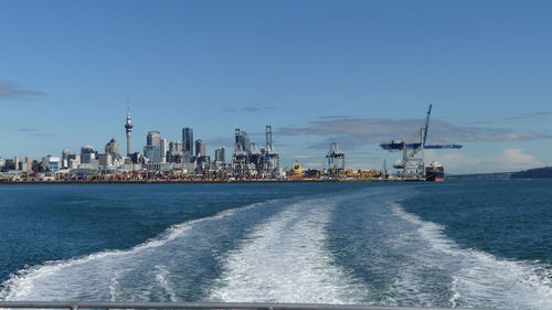 Boats in sea against clear sky