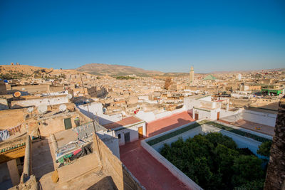 High angle view of townscape against clear blue sky