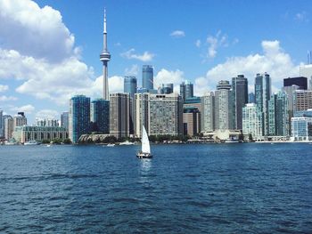 Cityscape by lake ontario against sky