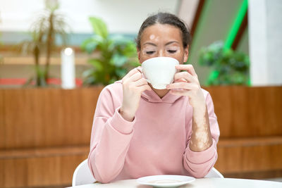 Portrait of man holding coffee cup