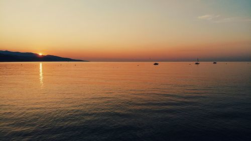 Scenic view of sea against orange sky