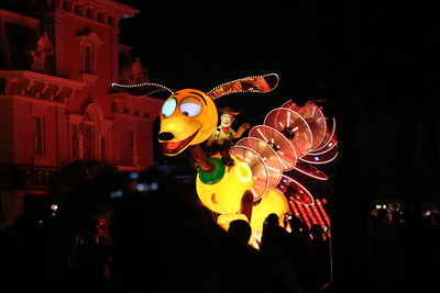 People in illuminated stage at night