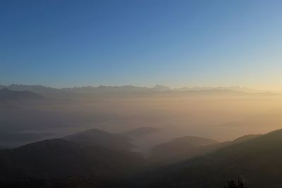 Scenic view of mountains against sky during sunset