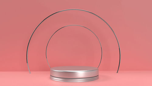 Close-up of glass on table against red background