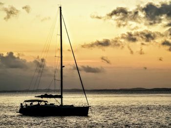 Silhouette sailboat on sea against sky during sunset