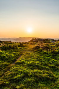 Scenic view of field against sky during sunset