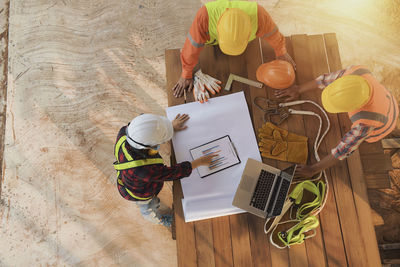 High angle view of people working on table