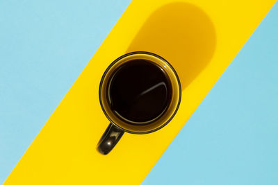 Close-up of yellow object against blue background