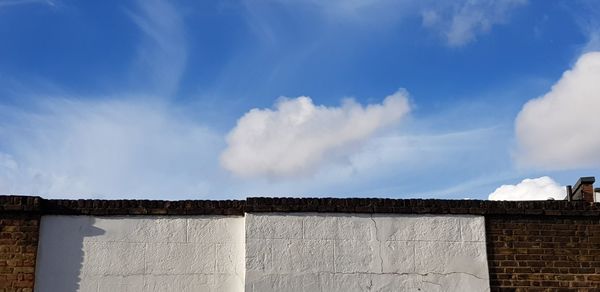 Low angle view of building against cloudy sky