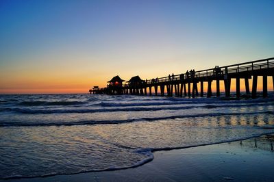 Scenic view of sea against clear sky during sunset