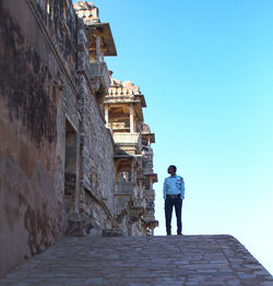 Rear view of man walking on street