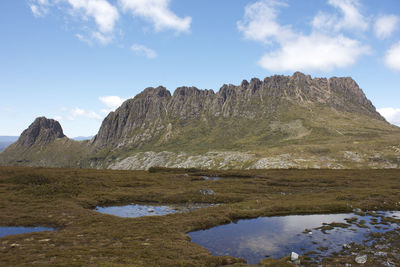 Scenic view of mountains against cloudy sky