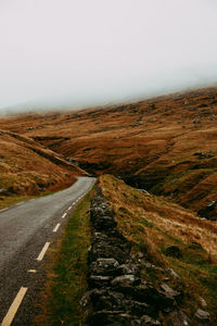 Road amidst landscape against clear sky