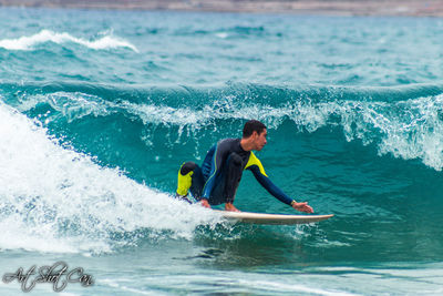 Side view of man surfing in sea