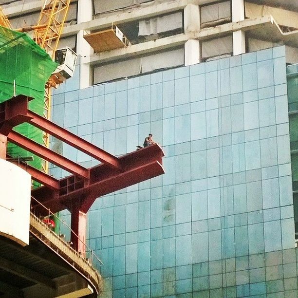 architecture, building exterior, built structure, window, building, balcony, residential building, low angle view, residential structure, house, day, reflection, modern, blue, glass - material, sunlight, no people, outdoors, city, chair