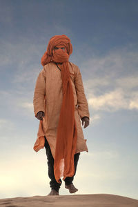 Full length of woman standing against sky