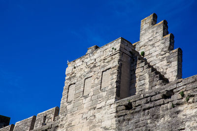 Low angle view of historic building against blue sky