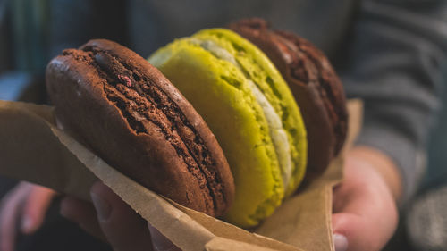 Close-up of human hand holding macaroons 