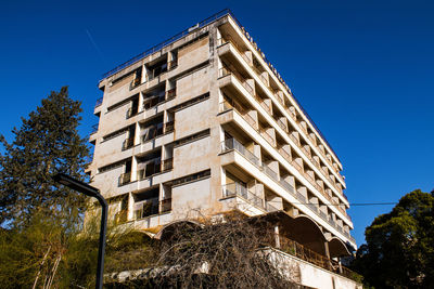 Low angle view of building against clear blue sky