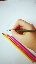 Close-up of multi colored pencils on white background