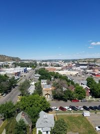 High angle view of buildings against blue sky