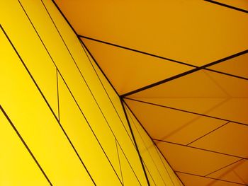 Low angle view of yellow building against sky