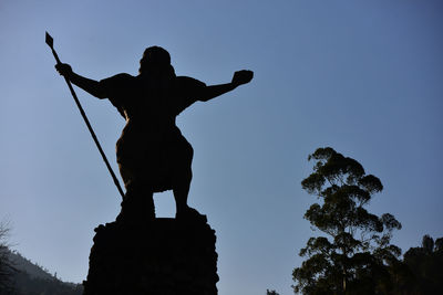 Low angle view of statue against blue sky