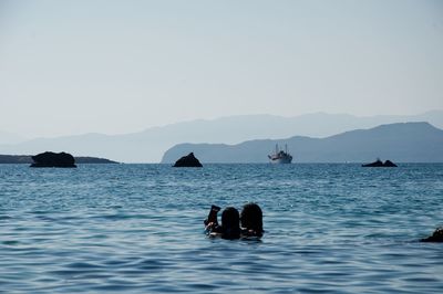 Couple in sea against sky