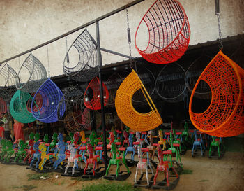 Multi colored umbrellas hanging for sale at market stall