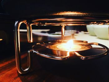 Close-up of illuminated lamp on table