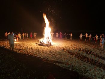 Group of people on beach at night