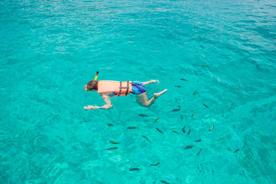 High angle view of woman snorkeling in turquoise sea