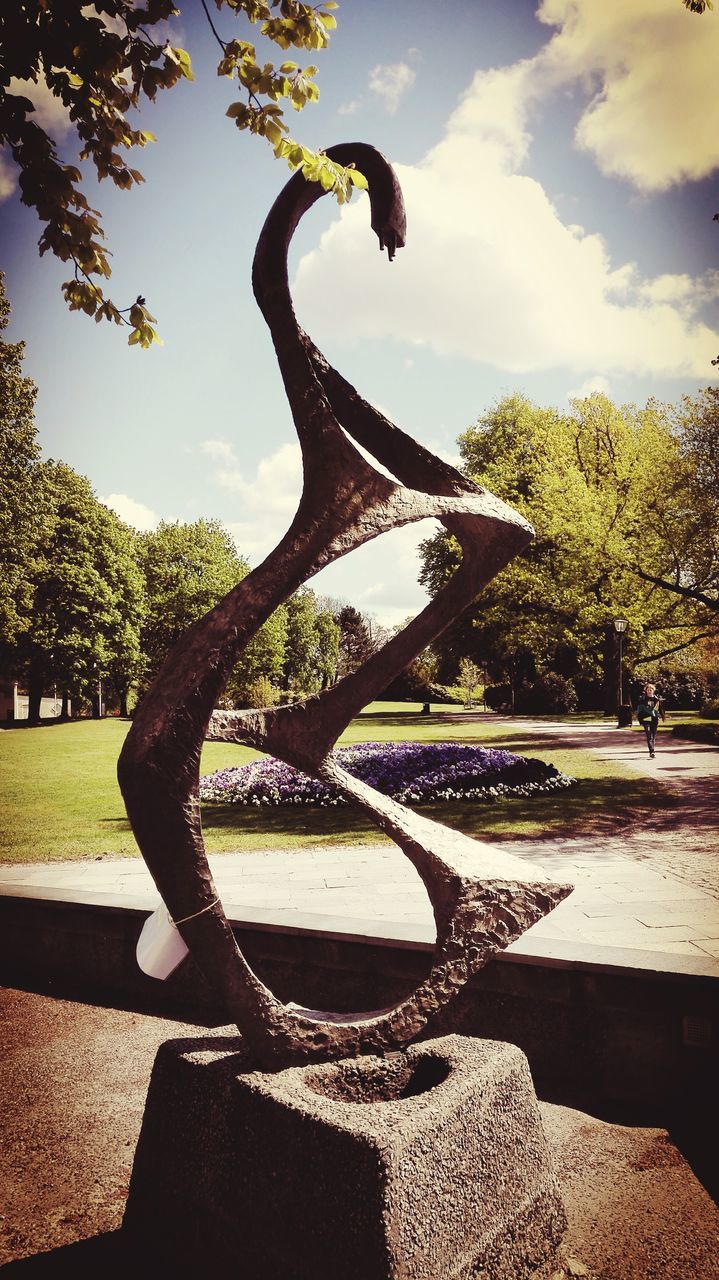 tree, sky, sunlight, park - man made space, shadow, growth, cloud - sky, nature, day, built structure, cloud, outdoors, no people, metal, art and craft, tranquility, architecture, branch, close-up, art