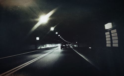 Illuminated tunnel at night